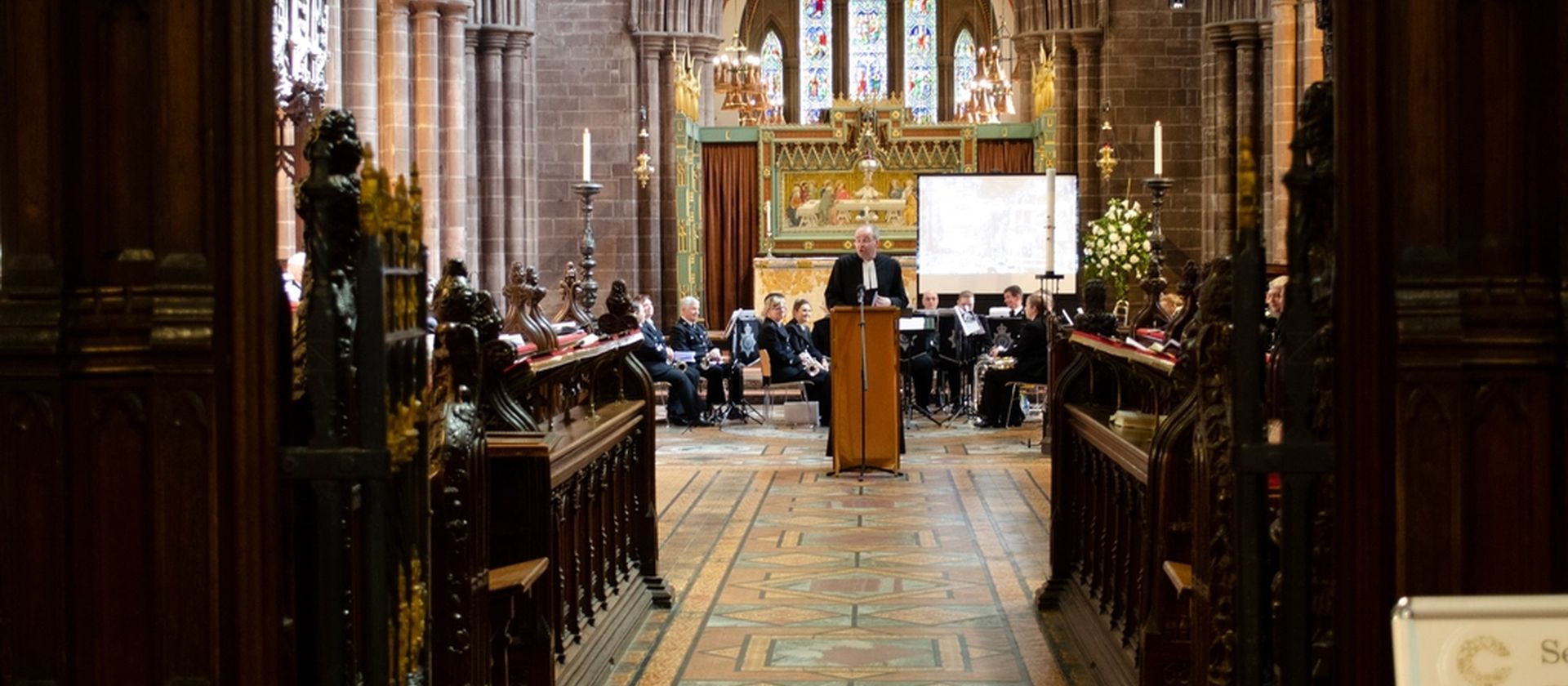 The interior of a church with people gathered toward the front