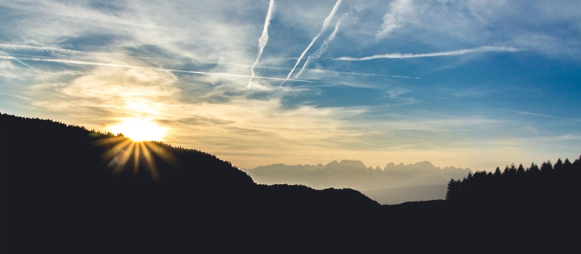 The sun rising over a mountain ridge at daybreak